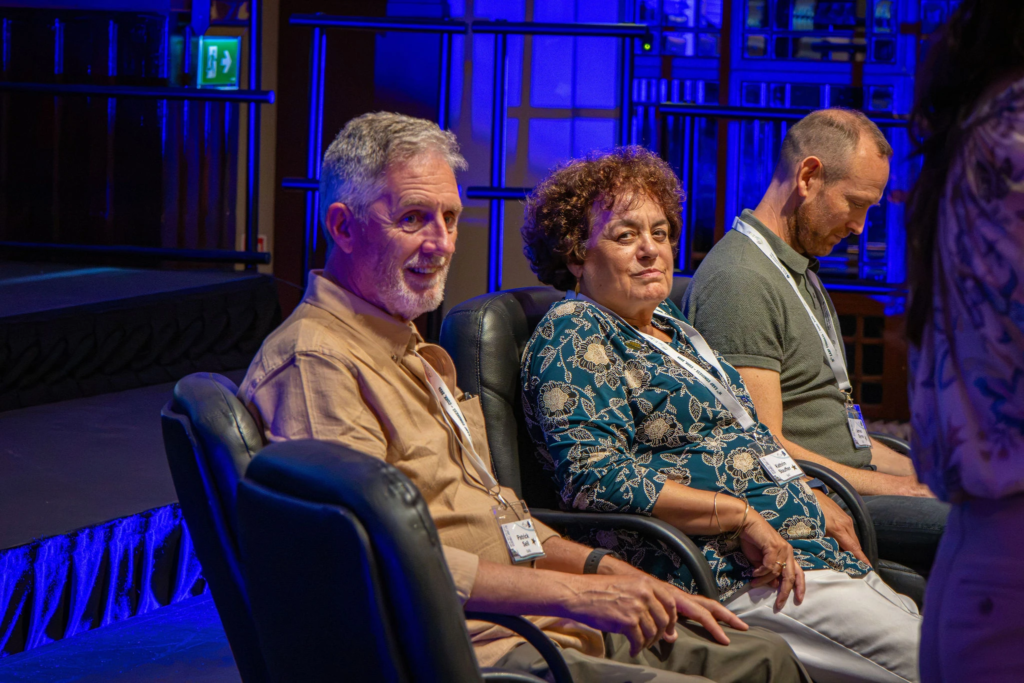 Panel of three speakers and experts sitting on stage during a business conference and corporate seminar.